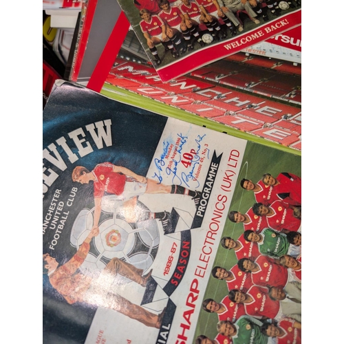 25B - A collection of Manchester United programmes, pictures etc, some with signatures.