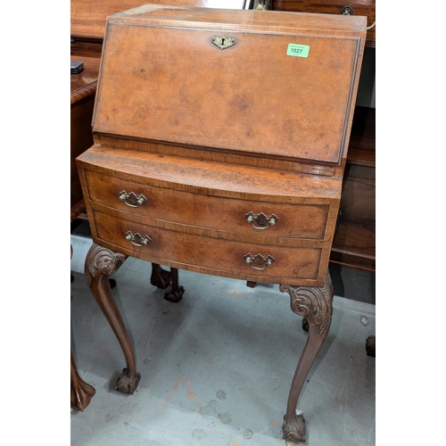 1027 - A walnut bureau of small proportions with fall front and two drawers below, on cabriole legs.