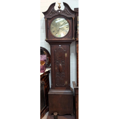 997 - A late 18th Century/early 19th Century carved oak longcase clock with swan neck pediment, ball finia... 