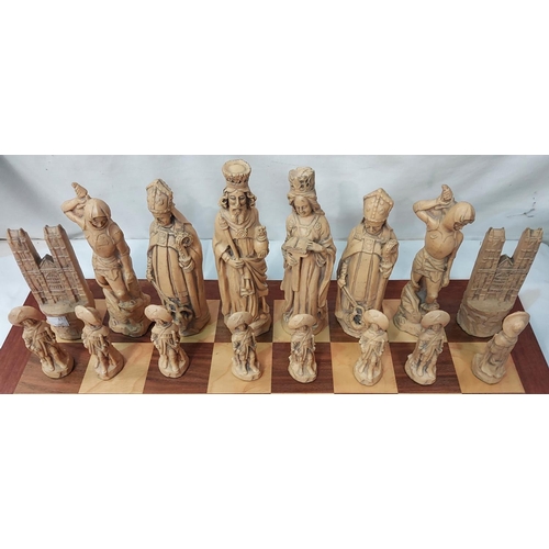 69 - A coffee table chess set with Medieval style ebony and ivory coloured pieces.