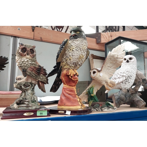 98 - Three resin figures of eagles including one with eaglets; four modern resin owl figures.