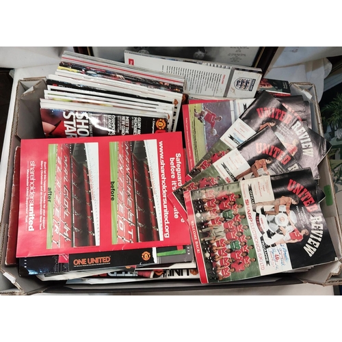 25B - A collection of Manchester United programmes, pictures etc, some with signatures.