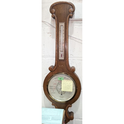 62A - An oak cased aneroid barometer with thermometer (glass a/f);a set of brass and iron kitchen scales; ... 