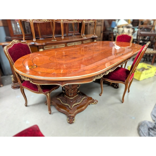 1049 - A Louis XVI style dining table and chairs with burr walnut and inlaid decoration with gilt highlight... 