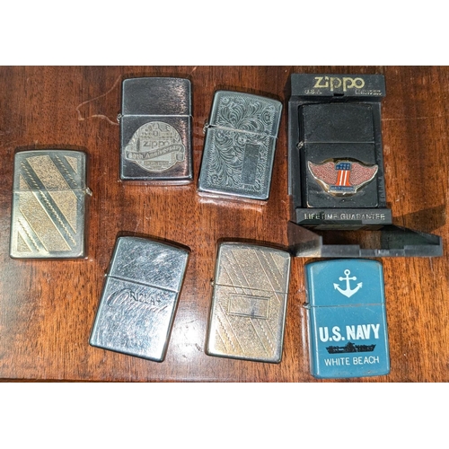 160A - A collection of seven Zippo lighters