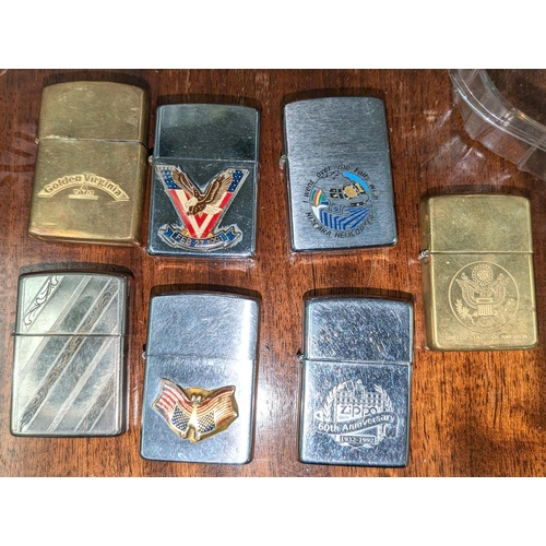 160B - A collection of seven Zippo lighters