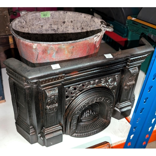 163 - A Victorian cast iron fire front and a galvanised fire bucket.