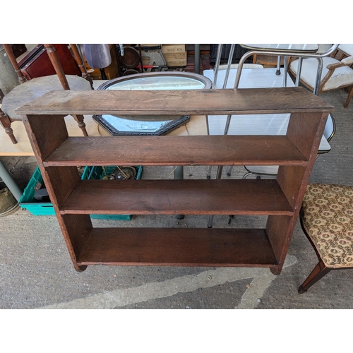 993 - A large oak three-height shelf unit and a wall hanging glass doored cabinet plus an oak chest.