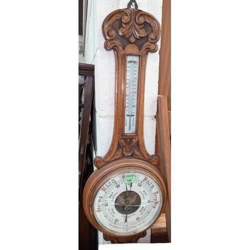 132 - A carved oak aneroid barometer by Schierwater & LLoyd Liverpool (glass a.f)