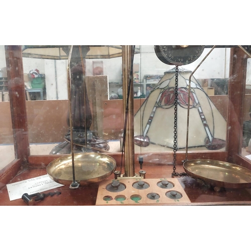 142 - A balance scale by Griffin and George Ltd in glass case, three smaller weights missing; a modern mic... 