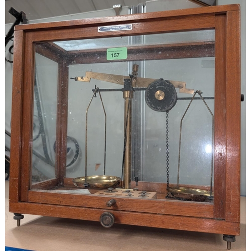 142 - A balance scale by Griffin and George Ltd in glass case, three smaller weights missing; a modern mic... 