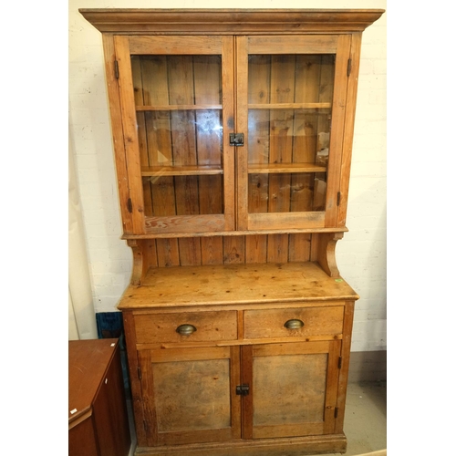 1017 - A Victorian pine farmhouse dresser with two glazed doors above, with drawers and cupboards below, he... 