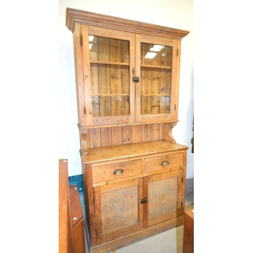 1017 - A Victorian pine farmhouse dresser with two glazed doors above, with drawers and cupboards below, he... 