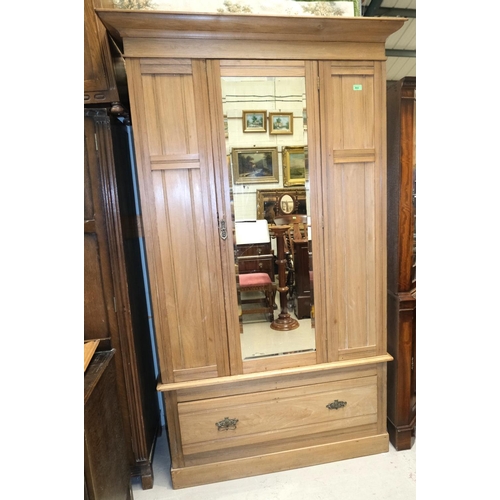 1018 - A stripped mahogany single mirror door wardrobe with drawer below.