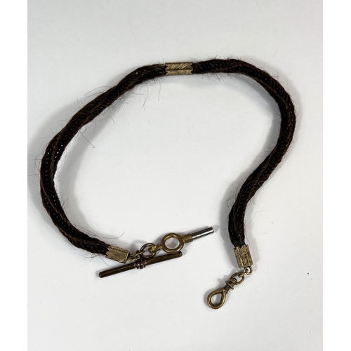 768 - A Victorian mourning plaited hair watch chain with gilt metal mounts.