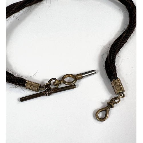 768 - A Victorian mourning plaited hair watch chain with gilt metal mounts.