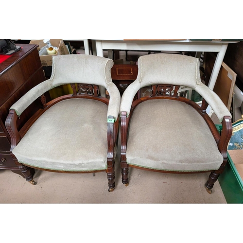 982 - A pair of late 19th Century/early 20th Century mahogany tub chairs with pierced galley back in a sag... 