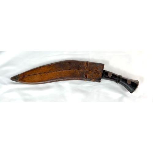 210 - A British military Nepalese fighting Kukri with broad arrow marks to hilt and leather scabbard, with... 