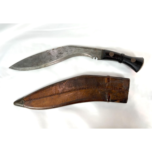 210 - A British military Nepalese fighting Kukri with broad arrow marks to hilt and leather scabbard, with... 