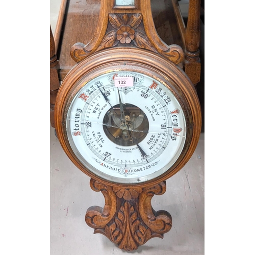 132 - A carved oak aneroid barometer by Schierwater & LLoyd Liverpool (glass a.f)