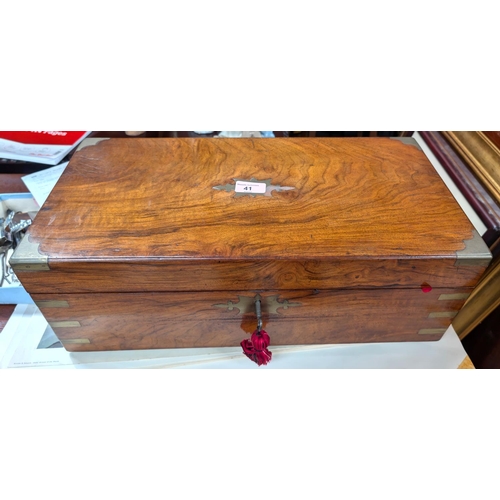 41 - A walnut writing desk with surface on the interior, brass bindings etc.