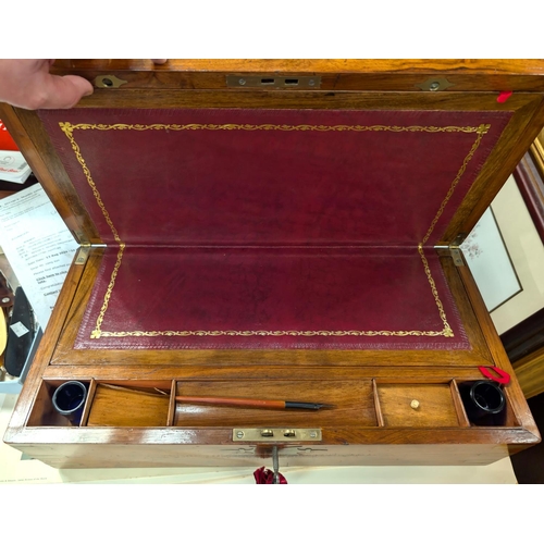 41 - A walnut writing desk with surface on the interior, brass bindings etc.