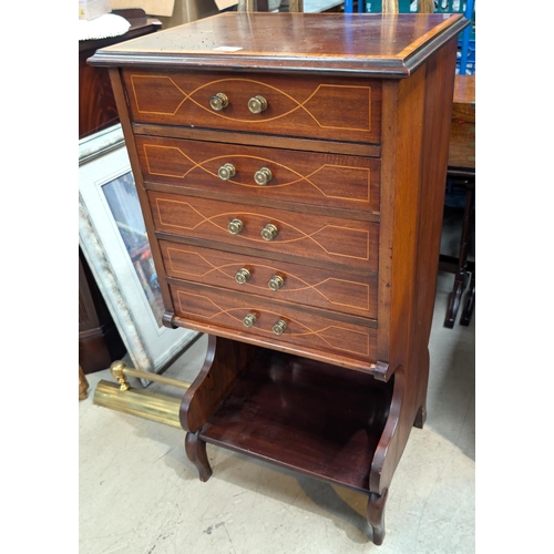 877 - An Edwardian mahogany inlaid music cabinet, hinged lid, and four drawers, shelf below.