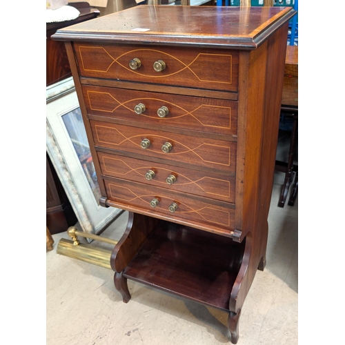 877 - An Edwardian mahogany inlaid music cabinet, hinged lid, and four drawers, shelf below.