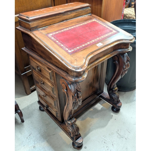 878 - A stained wood reproduction Davenport with leather writing surface and drawers to one side.