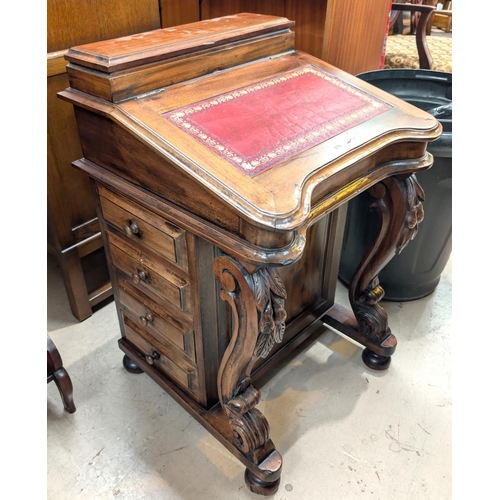 878 - A stained wood reproduction Davenport with leather writing surface and drawers to one side.