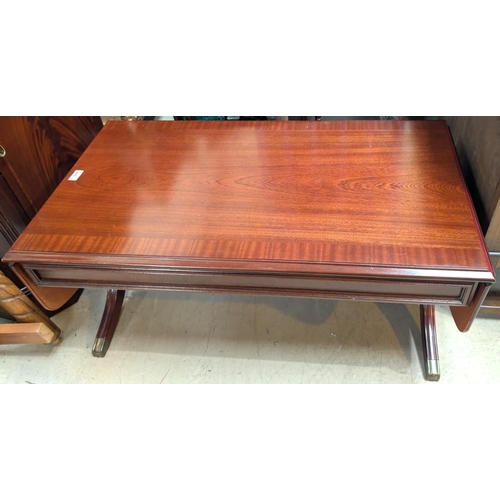 880 - A mahogany drop leaf coffee table and a similar nest of tables.