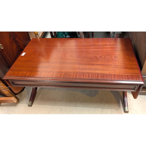 880 - A mahogany drop leaf coffee table and a similar nest of tables.