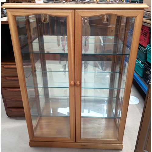 885 - a modern light wood display cabinet, three height.