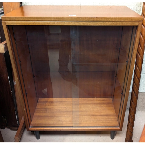 921 - A teak mid 20th century sliding door, three height book case.