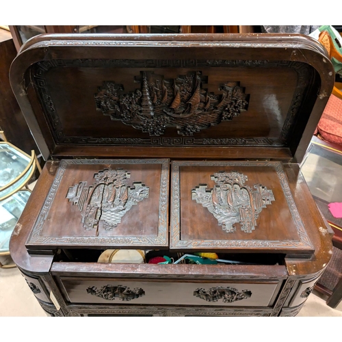 1001 - A 1920's Chinese carved cocktail cabinet with carved parrots, rounded form, pop up secret compartmen... 