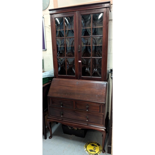 1003 - A Victorian mahogany bureau bookcase with converse glass two door top and tithed fall front