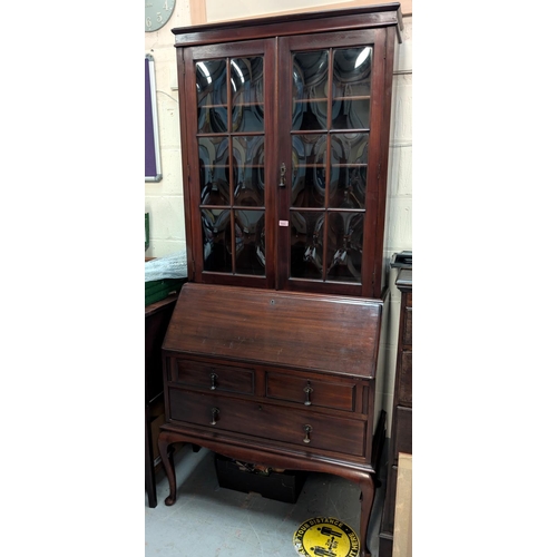 1003 - A Victorian mahogany bureau bookcase with converse glass two door top and tithed fall front