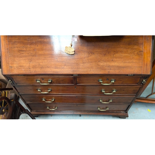 1005 - A large Georgian mahogany bureau with decorative interior with secret compartments, three long and t... 