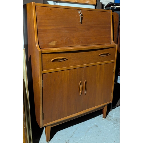 1010 - A mid 20th Century teak G-Plan style bureau with fall front and drawers under.