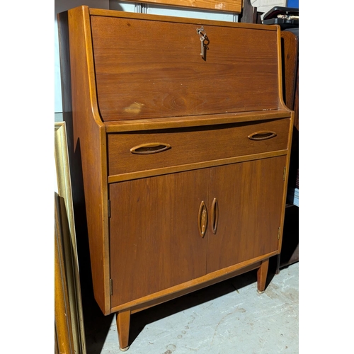 1010 - A mid 20th Century teak G-Plan style bureau with fall front and drawers under.