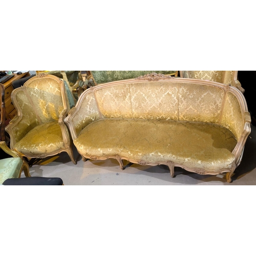 1024 - A Louis XV style gilt three piece drawing room suite in gilt and cream upholstery with three seater ... 