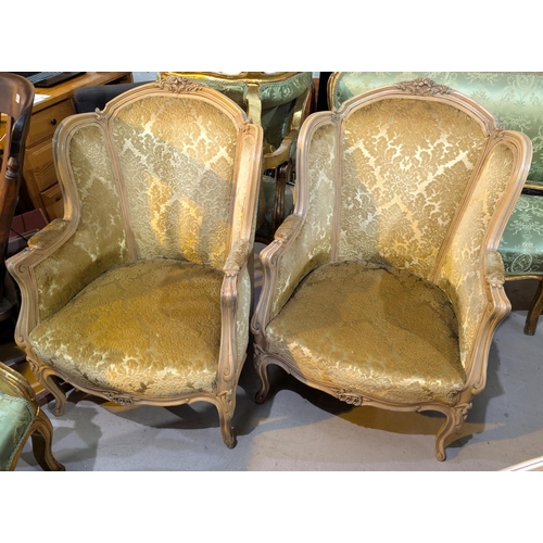 1024 - A Louis XV style gilt three piece drawing room suite in gilt and cream upholstery with three seater ... 