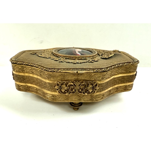 103 - A late 19th century continental gilt metal jewellery box with central enamelled plaque, 15cm