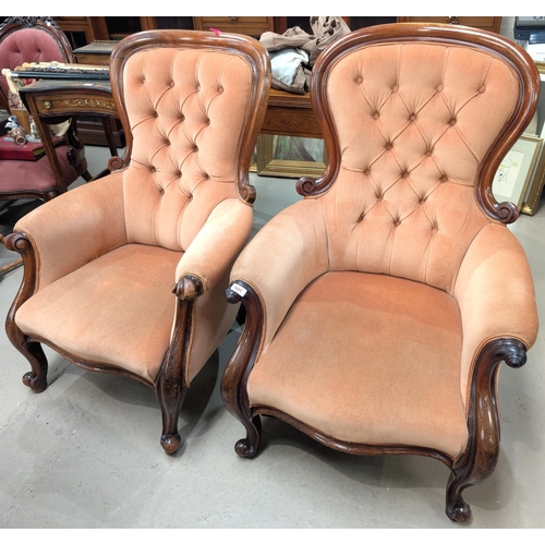 1031 - A pair of Victorian deeply buttoned back lady and gentleman armchairs with high backs.