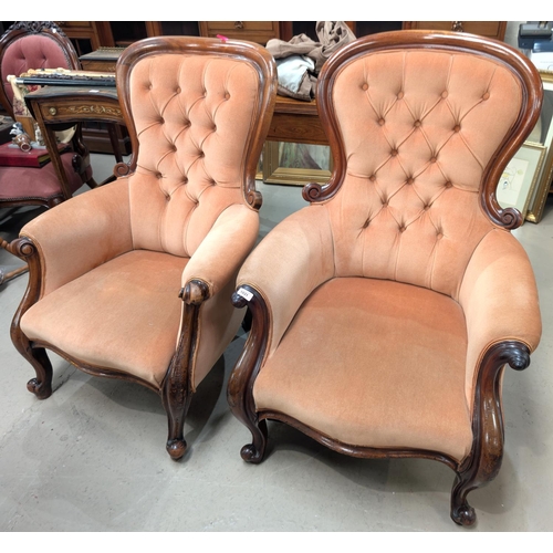 1031 - A pair of Victorian deeply buttoned back lady and gentleman armchairs with high backs.