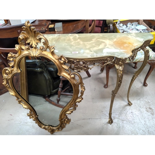 1032 - A gilt metal and onyx console table and similar gilt framed mirror.