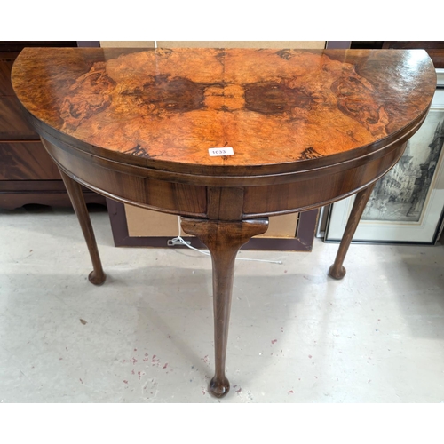 1033 - A 19th Century burr walnut demi line fold over card table with rear extending leg cabriole with pad ... 