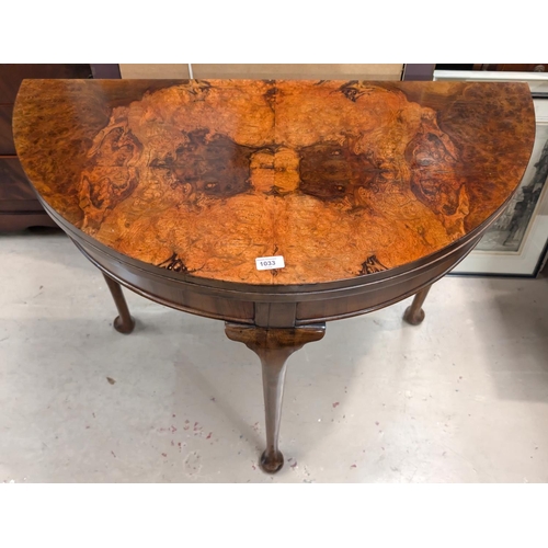 1033 - A 19th Century burr walnut demi line fold over card table with rear extending leg cabriole with pad ... 