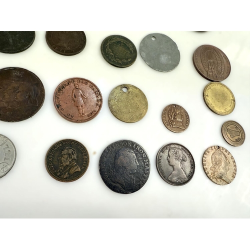 228 - A collection of 25 tokens, 18th-20th Century.