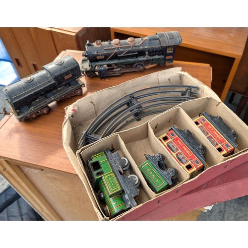 309 - A Brimtoy tin plate boxed train set; an 'O' gauge Lionel Corporation train and another.